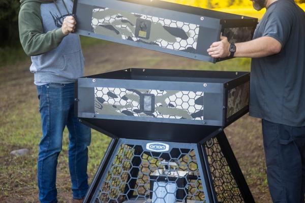 two men building a deer feeder