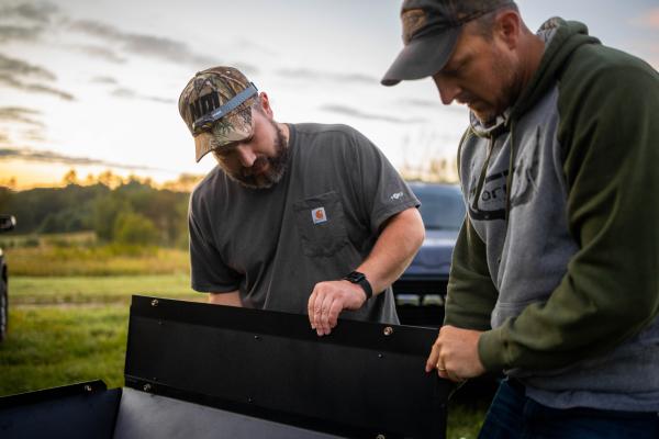 two men inspecting material