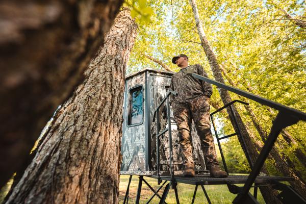 man standing on blind stand