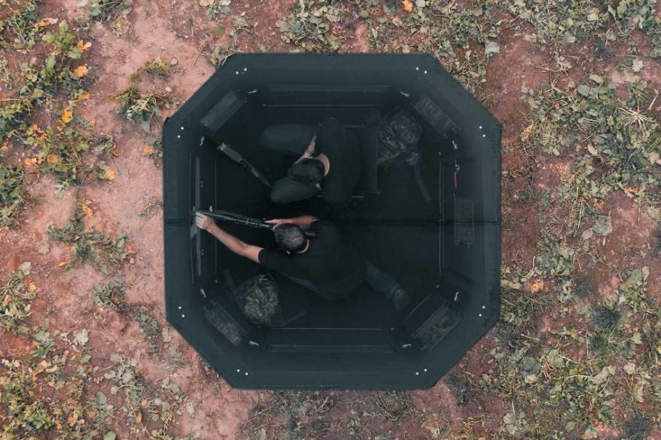two adults in a hunting blind 