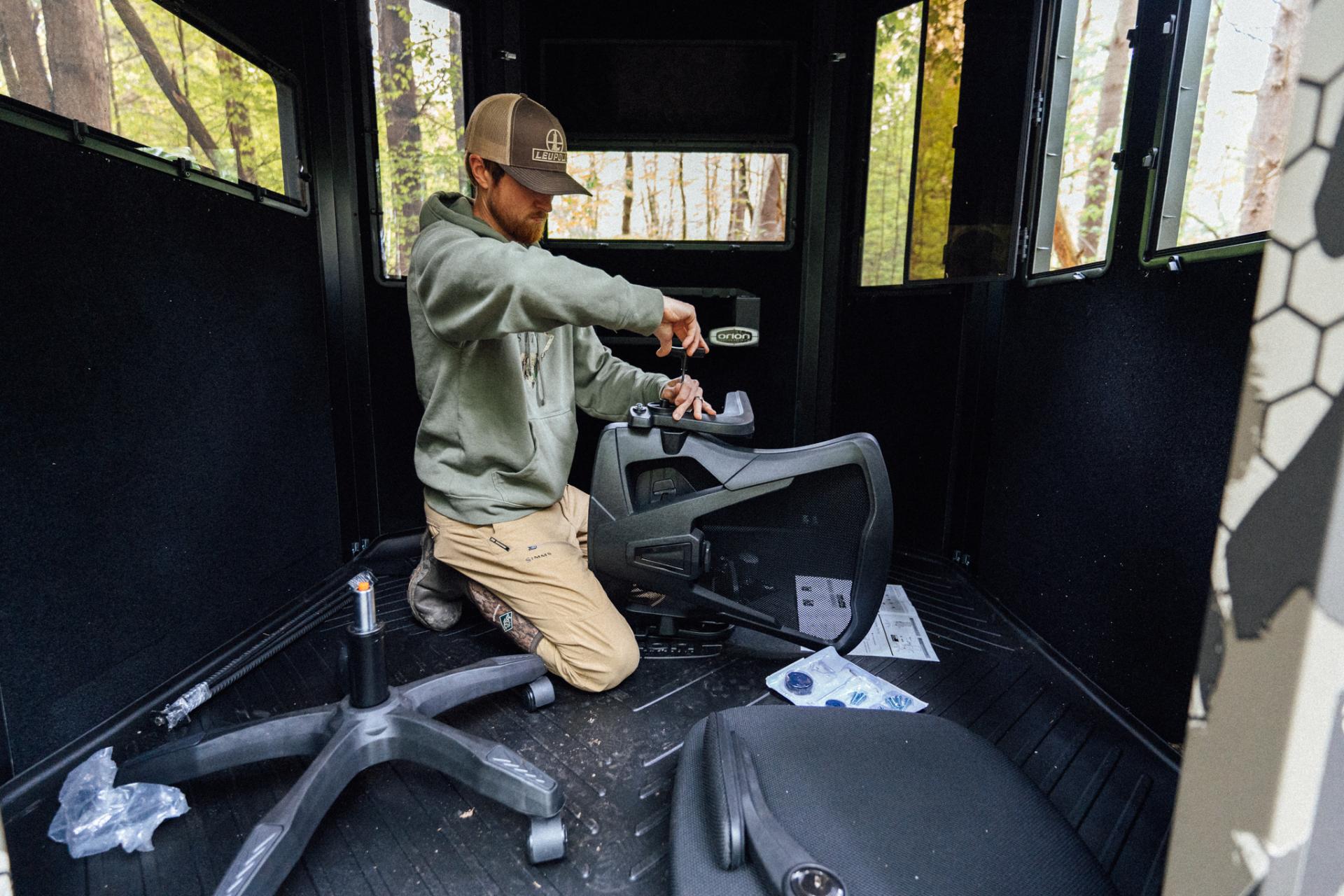man working inside a blind 